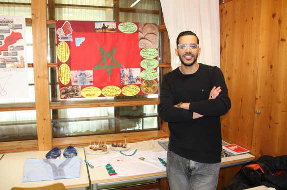 Auszubildende der generalistischen Pflegeausbildung mit Plakaten zur Pflege in ihren Heimatländern bzw. anderen Ländern